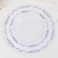 Elegant white plates with blue decorative borders, stacked together.