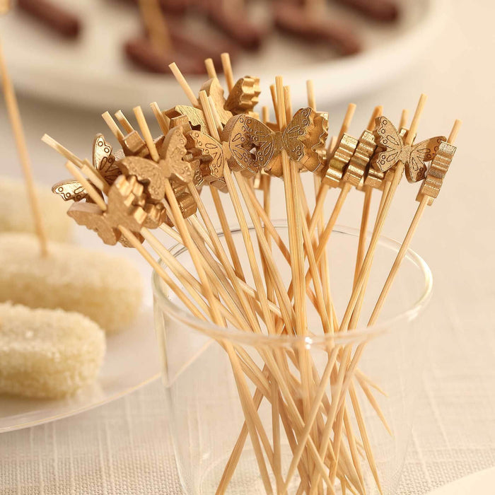 Butterfly-themed party food picks in a glass container.
