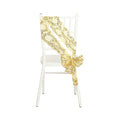 Gold floral chair sash draped on a white chiavari chair.