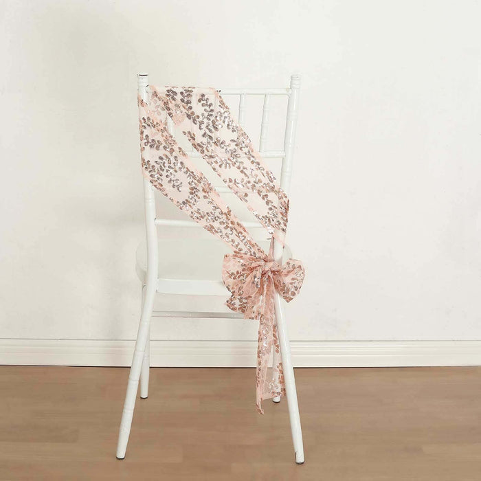 Pink floral ribbon tied around a white chair in a simple setting.