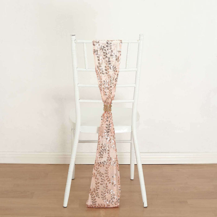 Rose gold sequin chair sash draped on a white chair.