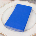 Stack of blue napkins on a decorative plate.