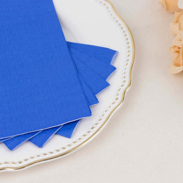 Blue cardstock sheets on a decorative plate.