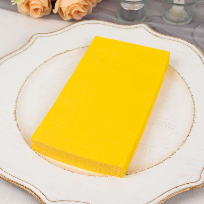 Yellow paper sheets stacked on a decorative plate.