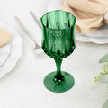 Green decorative glass goblet on a table setting.
