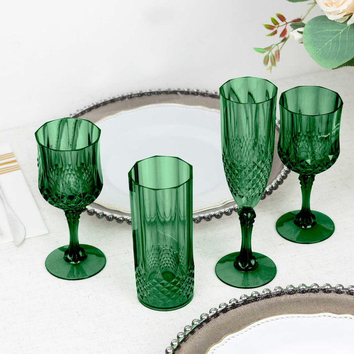 Set of four elegant green glassware pieces on a table.