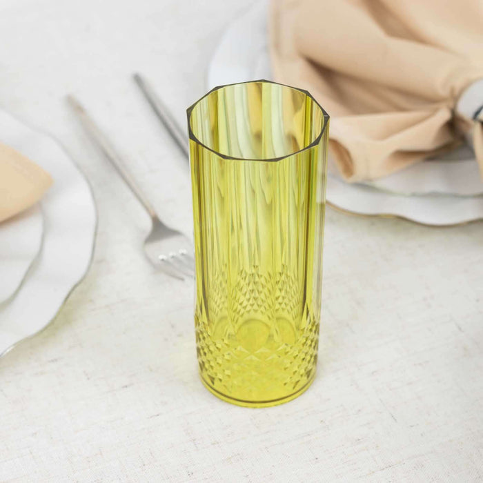 Yellow textured glass vase on a table setting with napkin and cutlery.