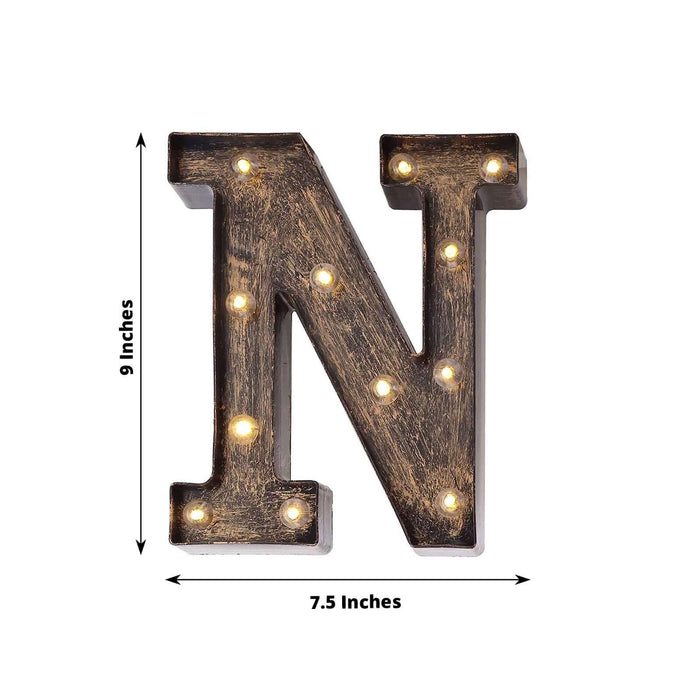 Light-up decorative letter "N" sign, vintage style with bulbs.