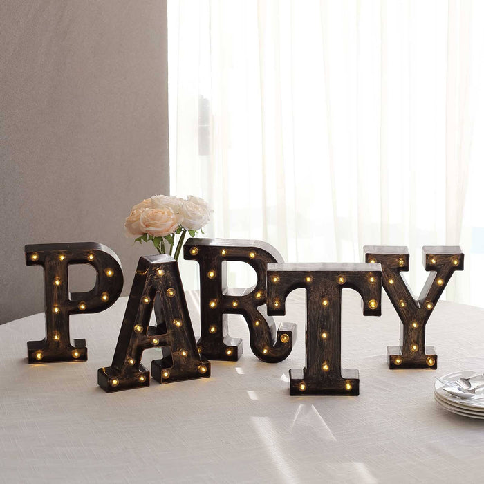 Light-up PARTY letters for festive decoration on a table.