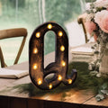 Decorative marquee letter "Q" with lights, styled for event decor.
