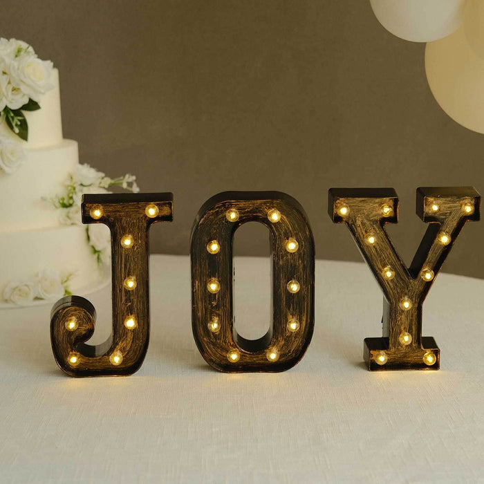 Decorative illuminated "JOY" letters for festive celebrations.