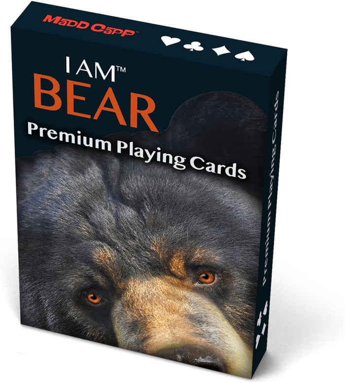 A box of MADD CAPP 'I AM BEAR' Premium Playing Cards, featuring a close-up photo of a black bear on the front cover with orange lettering and playing card suit icons at the top.