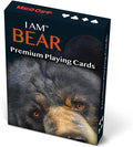 A box of MADD CAPP 'I AM BEAR' Premium Playing Cards, featuring a close-up photo of a black bear on the front cover with orange lettering and playing card suit icons at the top.
