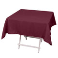 Burgundy tablecloth draped over a folding table