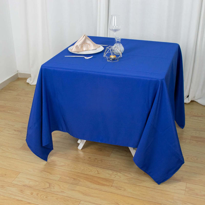 Blue tablecloth draped over a table with dining accessories.