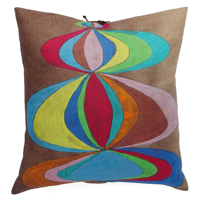 A linen pillow with a colorful geometric pattern and leather tie closure on white background. Designed by Michele Varian and made in New York.