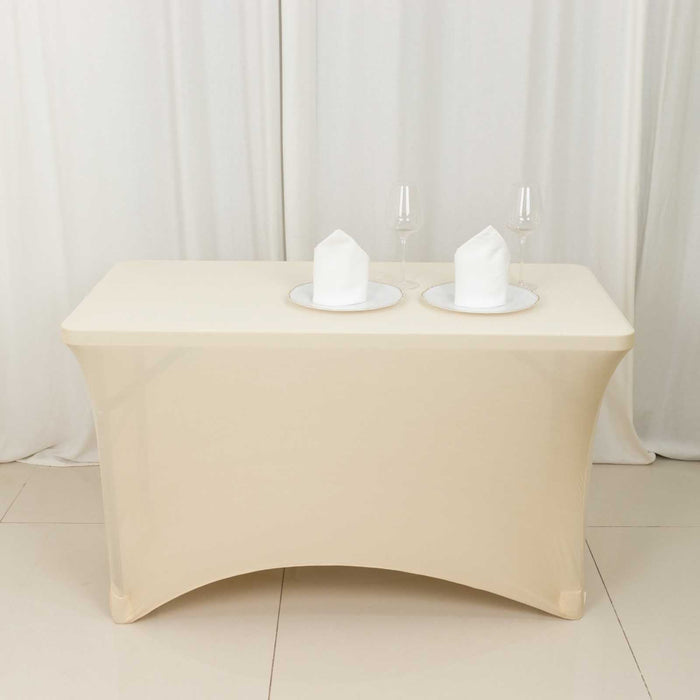 Beige table with white napkins and glasses on a plain background