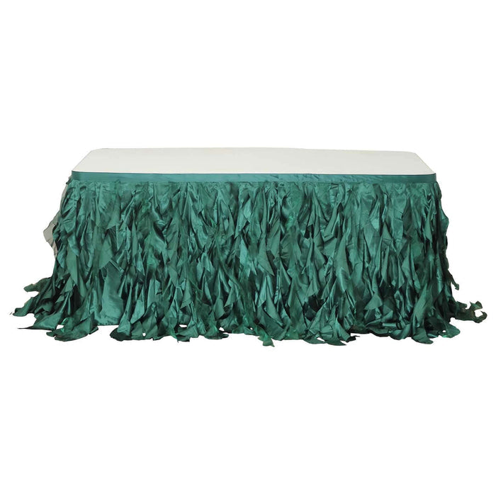 Green table skirt with a ruffled design, perfect for events and parties.
