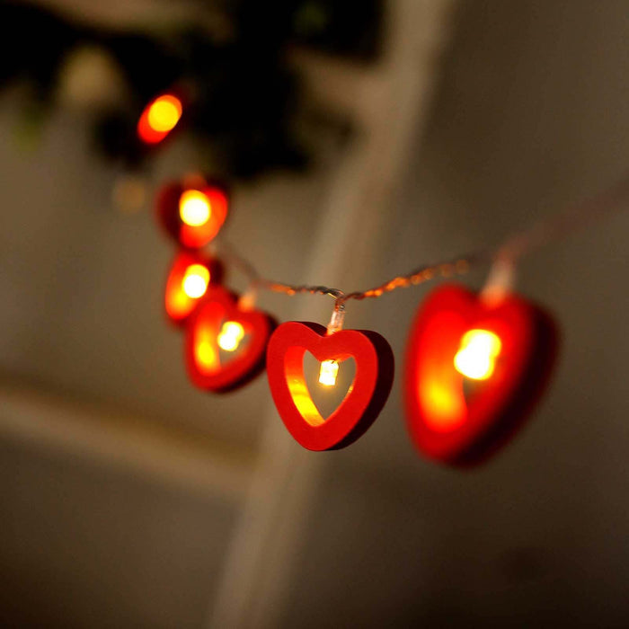 Red heart-shaped string lights glowing warmly.